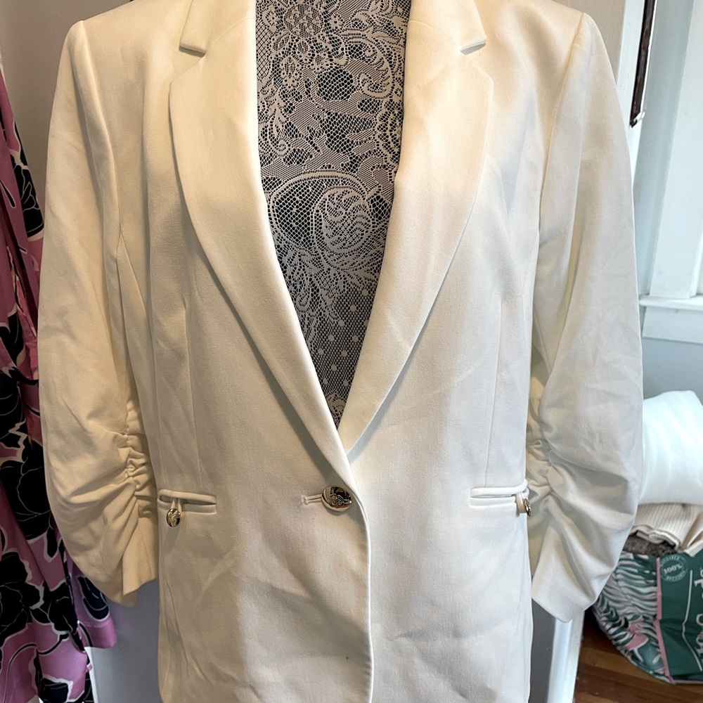 Tahari blazer with gold buttons and shirred sleeves that look pushed up.